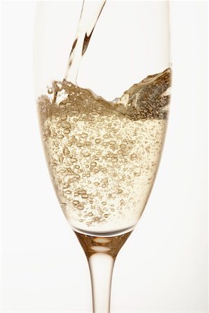 effervescing - Champagne being poured into glass, close up, in studio Stock Photo - Premium Royalty-Free, Code: 693-03303069