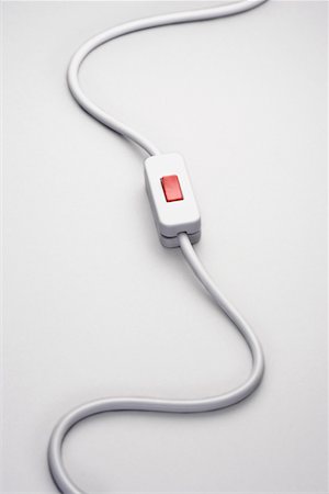 Switch on power cord, against white background in studio Foto de stock - Sin royalties Premium, Código: 693-03303075