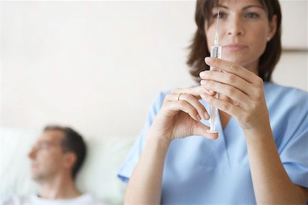 female nurse male patient injection - Nurse Preparing syringe For Injection, focus on syringe Stock Photo - Premium Royalty-Free, Code: 693-03303152