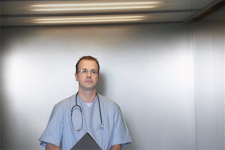 Physician Waiting in Elevator, portrait Stock Photo - Premium Royalty-Free, Code: 693-03303166