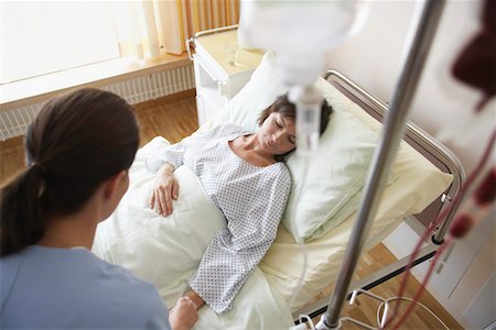 patient on bed and iv - Nurse With Patient in Hospital Room, high angle view Stock Photo - Premium Royalty-Free, Code: 693-03303161