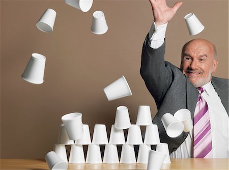 simsearch:693-03303629,k - Businessman knocking down pyramid of plastic cups Foto de stock - Sin royalties Premium, Código: 693-03303290