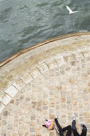 seagull looking down - Couple Relaxing by canal, low section, view from above Stock Photo - Premium Royalty-Free, Code: 693-03303365