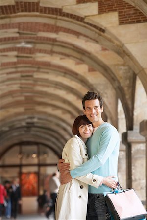 shopping in paris - Couple Hugging in Shopping Arcade Stock Photo - Premium Royalty-Free, Code: 693-03303397