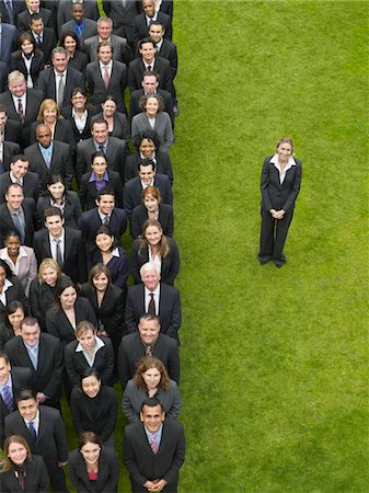 Business woman standing next to large group of business people in formation, elevated view, portrait Stock Photo - Premium Royalty-Free, Code: 693-03303464