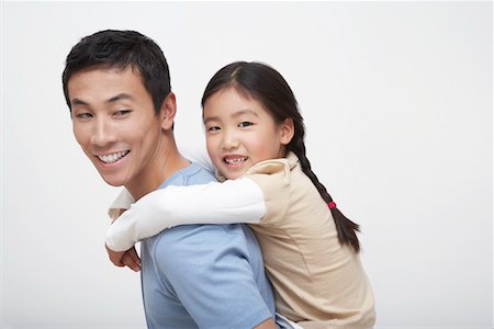 simsearch:693-03305063,k - Young Girl Getting Piggyback Ride with Father, side view Stock Photo - Premium Royalty-Free, Code: 693-03303550