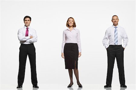 Businesspeople standing side by side, arms crossed, by side, in pockets Stock Photo - Premium Royalty-Free, Code: 693-03303661
