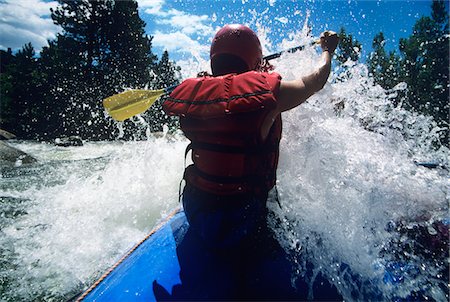 Kayaker paddling through Rapids, back view Stock Photo - Premium Royalty-Free, Code: 693-03303827