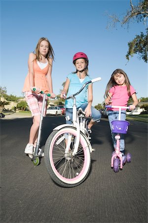 pictures of people riding scooters - Children with scooters and bicycle Stock Photo - Premium Royalty-Free, Code: 693-03314082