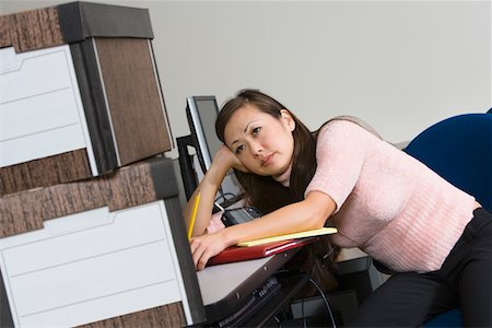 Bored Asian Businesswoman and Moving Boxes Stock Photo - Premium Royalty-Free, Code: 693-03314141