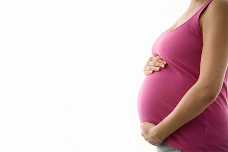 pregnant woman standing white background - Pregnant woman, mid section Stock Photo - Premium Royalty-Free, Code: 693-03314528