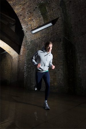 dark people running - Young man jogging through urban tunnel at night Stock Photo - Premium Royalty-Free, Code: 693-03315186