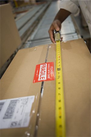 factory and closeup - Man measuring cardboard box, close-up Stock Photo - Premium Royalty-Free, Code: 693-03315335