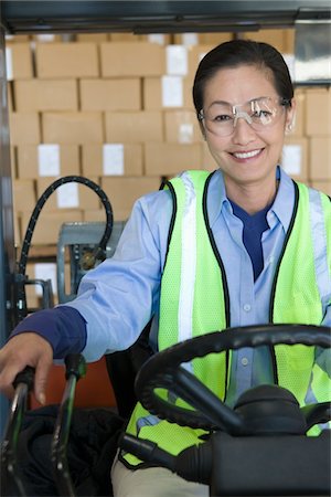 simsearch:693-03315336,k - Cheerful Asian woman working in distribution warehouse Stock Photo - Premium Royalty-Free, Code: 693-03315338