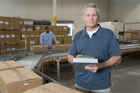 factory box conveyor belt - Man working in distribution warehouse Stock Photo - Premium Royalty-Free, Code: 693-03315365