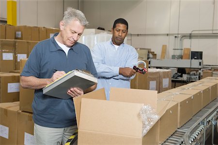 factory conveyor belt - Men inspecting goods in distribution warehouse Stock Photo - Premium Royalty-Free, Code: 693-03315369