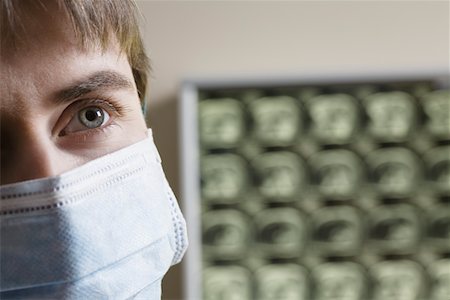 Doctor wearing surgical mask, close-up Stock Photo - Premium Royalty-Free, Code: 693-03316775