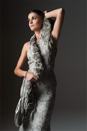 evening gown - Woman stands in grey evening dress and scarf Stock Photo - Premium Royalty-Free, Code: 693-03317153