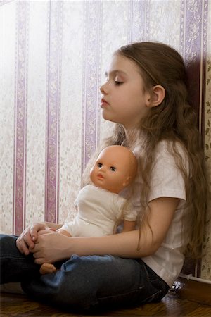 sad child toy - Girl with doll sitting in home Stock Photo - Premium Royalty-Free, Code: 693-03317178