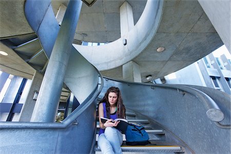 spiral staircase people - University student reading on staircase Stock Photo - Premium Royalty-Free, Code: 693-03317298