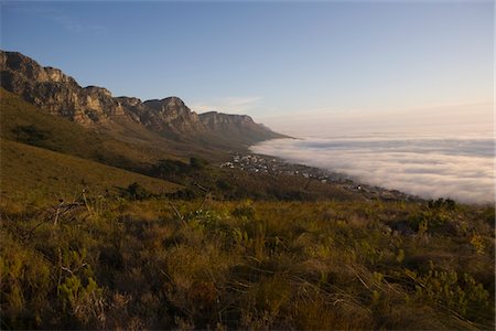 south african landscapes - The 12 Apostles of Table Mountain tower above Camps Bay and Bakoven Stock Photo - Premium Royalty-Free, Code: 693-03317539
