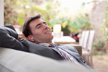 Businessman relaxing at home Stock Photo - Premium Royalty-Free, Code: 693-03317718