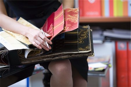swatch - Young designer looks through sample book Stock Photo - Premium Royalty-Free, Code: 693-03317980