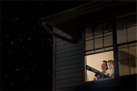 simsearch:693-03317739,k - Teenage boys stand with telescope at open window looking at night sky Stock Photo - Premium Royalty-Free, Code: 693-03317982