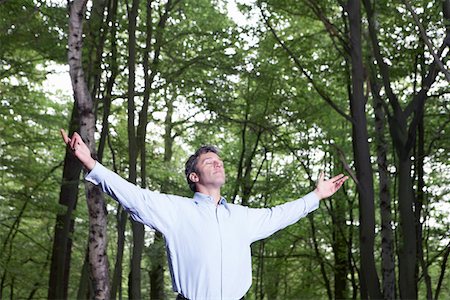 Enthusiastic Man smiling big, arms stretched out in front, palms