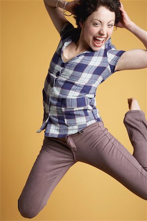 Young woman jumping and screaming Stock Photo - Premium Royalty-Free, Code: 693-03310863