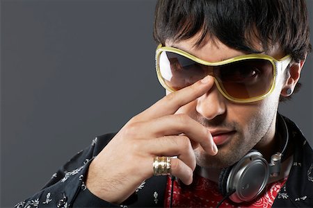 sunglasses on head - Young man wearing sunglasses and headphones, portrait, close-up Stock Photo - Premium Royalty-Free, Code: 693-03310886