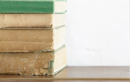 Stack of old books on wooden chest, close up Stock Photo - Premium Royalty-Free, Code: 693-03310941