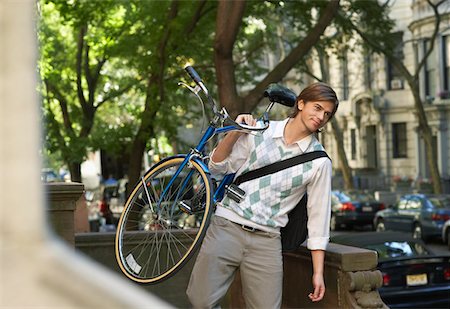 Man carrying bicycle, descending steps Stock Photo - Premium Royalty-Free, Code: 693-03311096