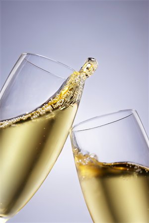 Two champagne glasses toasting, close-up Stock Photo - Premium Royalty-Free, Code: 693-03311159