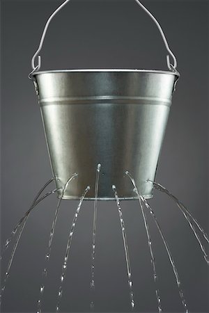 Water leaking from bucket Stock Photo - Premium Royalty-Free, Code: 693-03311151