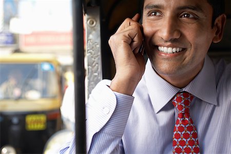simsearch:693-03311509,k - Business man using cell phone, smiling Stock Photo - Premium Royalty-Free, Code: 693-03311463