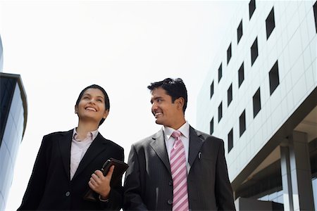 Business man cheering to city, back view Stock Photo - Premium Royalty-Free, Code: 693-03311530