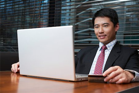 Business man using laptop in cafe Stock Photo - Premium Royalty-Free, Code: 693-03311613