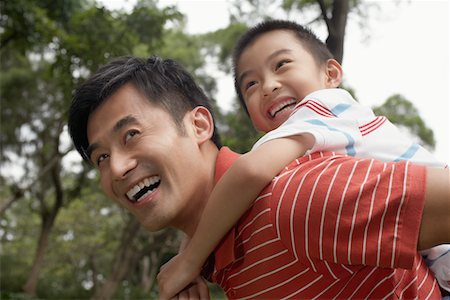 father with boy on shoulders - Father giving son piggyback (7-9) in park Stock Photo - Premium Royalty-Free, Code: 693-03311626