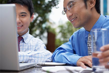 simsearch:693-03311509,k - Two business man using laptop sitting in outdoor cafe, close up Stock Photo - Premium Royalty-Free, Code: 693-03311620