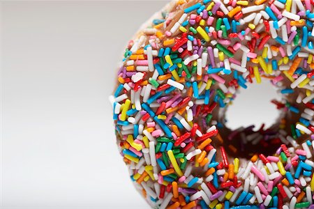 Rainbow sprinkles on doughnut Stock Photo - Premium Royalty-Free, Code: 693-03312113