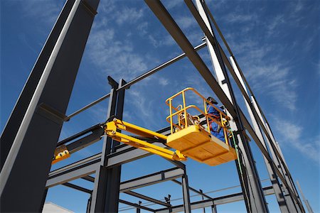 steel construction - Welder working from cherry picker on warehouse construction Stock Photo - Premium Royalty-Free, Code: 693-03312194