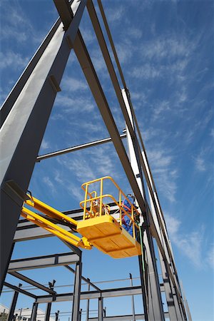 steel construction - Welder working from cherry picker on warehouse construction Stock Photo - Premium Royalty-Free, Code: 693-03312195