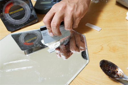 Close-up of man's hand and cocaine Stock Photo - Premium Royalty-Free, Code: 693-03312346