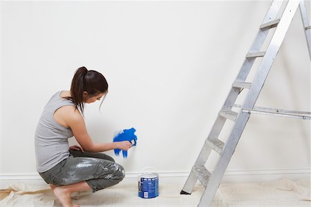 paint buckets for ladders - Woman painting wall Stock Photo - Premium Royalty-Free, Code: 693-03312695