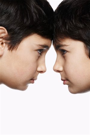 sibling portrait two people serious - Twin boys (13-15) head to head, close-up Stock Photo - Premium Royalty-Free, Code: 693-03312732