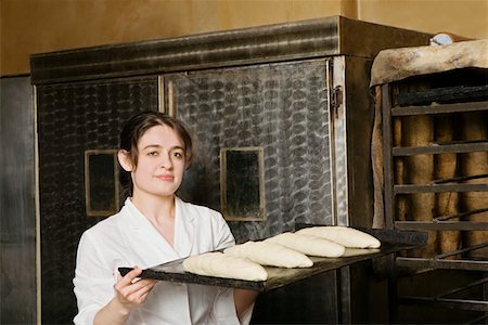 Baker Carrying Loaves of Bread Dough to Bake Stock Photo - Premium Royalty-Free, Code: 693-03312875