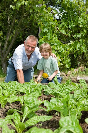 Boy gardening with grandfather, portrait Stock Photo - Premium Royalty-Free, Code: 693-03312920