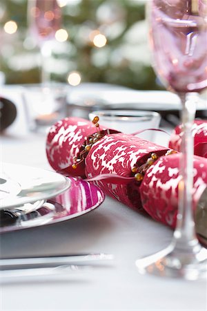 plate red wine glass - Christmas crackers on dining table Stock Photo - Premium Royalty-Free, Code: 693-03313012