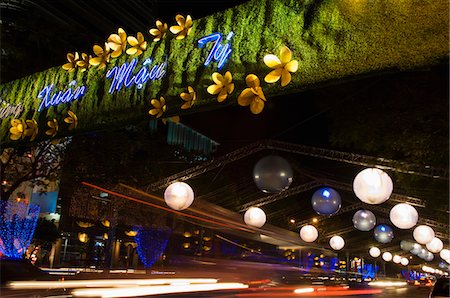 Traffic Beneath Mung Xuan Mau Ty Sign Stock Photo - Premium Royalty-Free, Code: 693-03313030